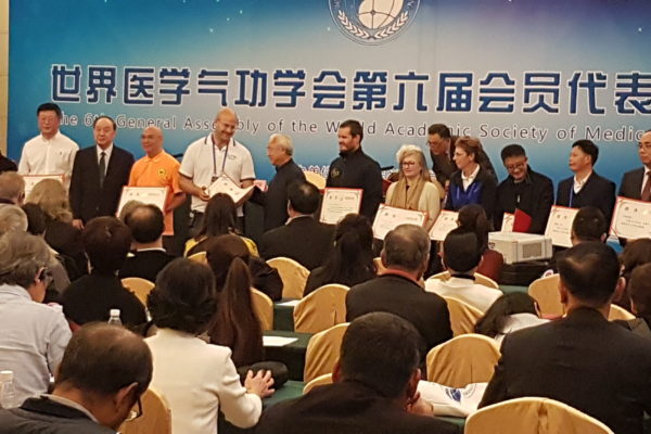 Receiving an award from the World Academic Society of Medical Qigong