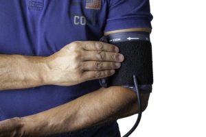 man with blood pressure monitor on his arm