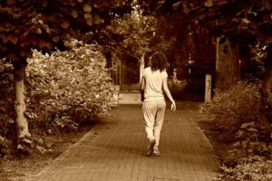 Picture of a woman walking in a park as a comparison for how dangerous qigong is