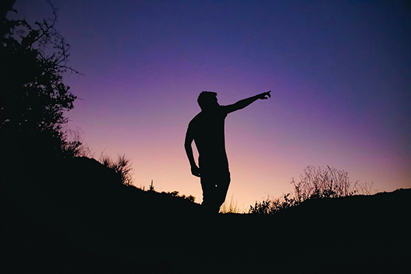 Man pointing a direction to show how understanding can help to take more control over the direction of your qigong journey