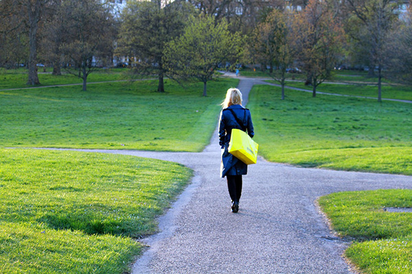 Girl on crossroad going the middle path to show how to avoid extremes and get full benefits from qigong practice 