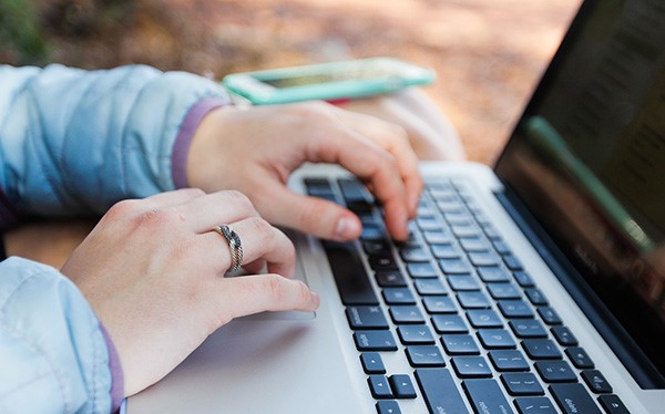 Person with the lap top to show the strengths and weaknesses of learning qigong online