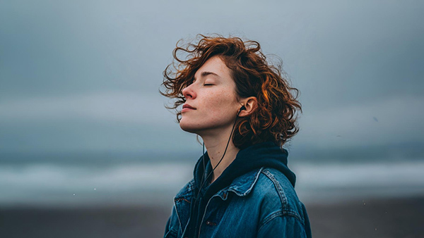 Blissful relaxed person to show how mindfulness reduces stress and anxiety, gives better emotional regulation and many other benefits