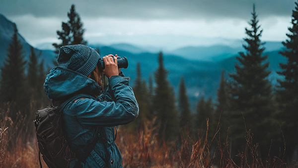 Person looking through binoculars to show the excitement about the plans for the next year