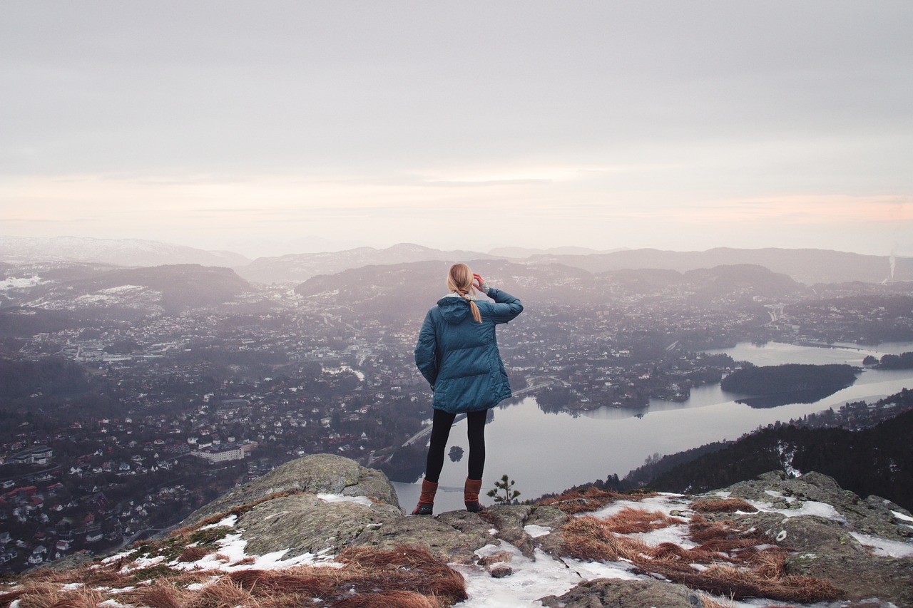 Image of woman looking over a vast landscape to get the big picture through review